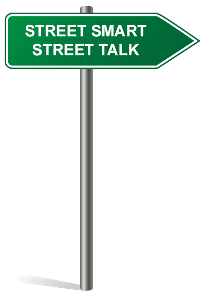 Green street sign with white text reading "STREET SMART STREET TALK," mounted on a silver pole and pointing to the right.